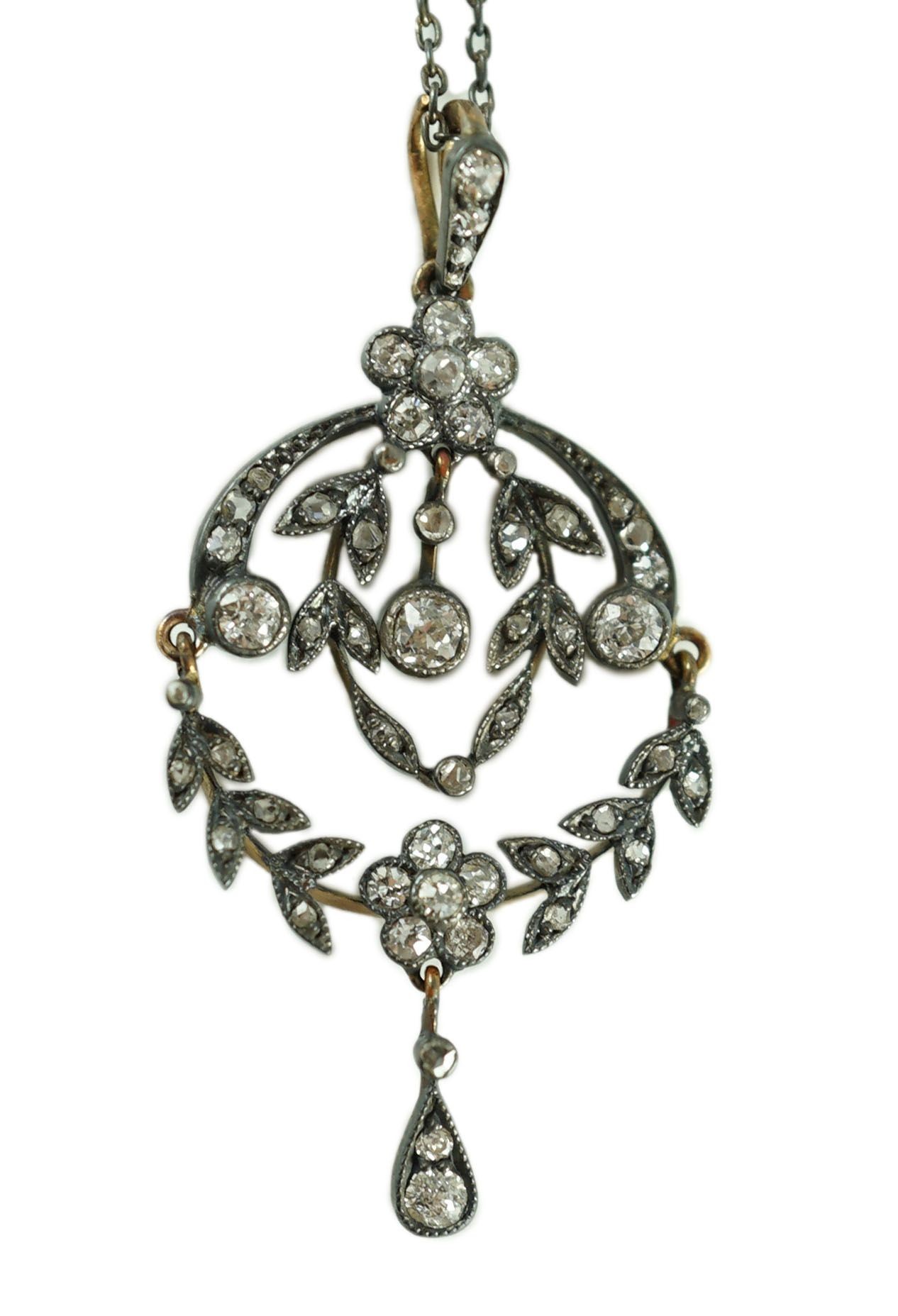 A 19th century gold, silver and diamond cluster set articulated drop pendant